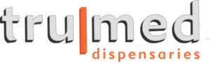 Logo with the words "trumed dispensaries" in gray and orange letters, with the "l" and "dispensaries" highlighted in orange.